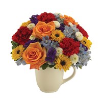 A Labor of Love flower bouquet in a white mug